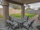 Covered patio with seating area and grassy backyard at 4330 E South Fork Dr, Phoenix, AZ 85044
