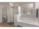 Relaxing bathroom featuring soaking tub and shower at 44230 W Palmen Dr, Maricopa, AZ 85138