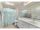 Charming bathroom with teal shower curtain at 44230 W Palmen Dr, Maricopa, AZ 85138