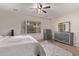 Spacious bedroom with large window and ceiling fan at 44230 W Palmen Dr, Maricopa, AZ 85138