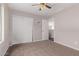 Spacious bedroom with ceiling fan and closet at 44230 W Palmen Dr, Maricopa, AZ 85138
