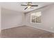 Bright bedroom featuring ceiling fan and carpet at 44230 W Palmen Dr, Maricopa, AZ 85138