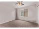 Cozy bedroom with ceiling fan and window at 44230 W Palmen Dr, Maricopa, AZ 85138