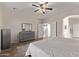 Bedroom with dresser and access to the bathroom and hallway at 44230 W Palmen Dr, Maricopa, AZ 85138