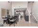 Bright dining area with a large table and chairs, open to the kitchen at 44230 W Palmen Dr, Maricopa, AZ 85138
