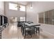 Dining area with dark wood table and chairs, view of living room and kitchen at 44230 W Palmen Dr, Maricopa, AZ 85138