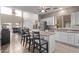 Modern kitchen with white cabinets, granite counters, and stainless steel appliances at 44230 W Palmen Dr, Maricopa, AZ 85138