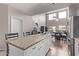 Kitchen island with granite countertop and seating for four at 44230 W Palmen Dr, Maricopa, AZ 85138