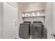 Laundry room with washer, dryer, and shelving at 44230 W Palmen Dr, Maricopa, AZ 85138