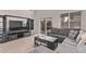 Living room with grey sectional sofa and backyard view at 44230 W Palmen Dr, Maricopa, AZ 85138