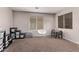Spacious playroom with window, chair, and toy storage at 44230 W Palmen Dr, Maricopa, AZ 85138