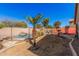 The spacious yard features a private pool area with mature landscaping, stone accents, and a fence surround at 44520 W Windrose Dr, Maricopa, AZ 85138