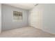 Cozy bedroom featuring a closet, neutral walls, carpet, and a bright window at 44520 W Windrose Dr, Maricopa, AZ 85138