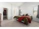 Bright bedroom with a walk-in closet, ensuite bathroom, plush carpet, and natural light from the window at 44520 W Windrose Dr, Maricopa, AZ 85138