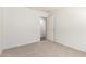 Well-lit bedroom with neutral walls, plush carpeting, and a doorway at 44520 W Windrose Dr, Maricopa, AZ 85138