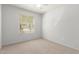 Bright bedroom featuring a window with blinds, neutral walls, carpet, and a ceiling fan at 44520 W Windrose Dr, Maricopa, AZ 85138
