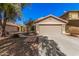 Charming single-story home featuring a two-car garage and desert landscaping at 44520 W Windrose Dr, Maricopa, AZ 85138