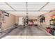 Spacious garage featuring ample storage, overhead lighting, and epoxy flooring at 44520 W Windrose Dr, Maricopa, AZ 85138