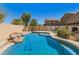 Private backyard oasis featuring a refreshing swimming pool and a well-maintained patio area at 44520 W Windrose Dr, Maricopa, AZ 85138
