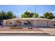 Ranch style home with arched entryway, landscaping, and a two-car garage at 4609 E Flower Ave, Mesa, AZ 85206