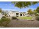 House with a large grassy backyard, gravel, and desert landscaping at 4937 S Pulse Ter, Mesa, AZ 85212