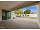 Covered patio overlooking a grassy backyard with desert landscaping at 4937 S Pulse Ter, Mesa, AZ 85212