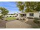 Brick patio, artificial turf, and a view of the home's exterior at 4937 S Pulse Ter, Mesa, AZ 85212