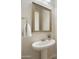 Powder room with pedestal sink and ornate mirror at 4937 S Pulse Ter, Mesa, AZ 85212