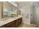 Double vanity bathroom with a large mirror and shower at 4937 S Pulse Ter, Mesa, AZ 85212