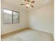 Bright bedroom with carpeted floor, window blinds, and ceiling fan at 4937 S Pulse Ter, Mesa, AZ 85212