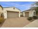 Two-car garage with tan doors and brick paver driveway at 4937 S Pulse Ter, Mesa, AZ 85212