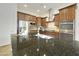 Kitchen island with double sink, granite countertop and stainless steel appliances at 4937 S Pulse Ter, Mesa, AZ 85212