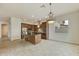Open concept kitchen with island, stainless steel appliances, and chandelier at 4937 S Pulse Ter, Mesa, AZ 85212