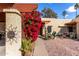 Inviting entryway with vibrant bougainvillea and a welcoming sign at 507 S Sand Verbena Way, Mesa, AZ 85208