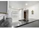 Modern kitchen with white cabinets, dark counters, and a view of the hallway at 507 S Sand Verbena Way, Mesa, AZ 85208
