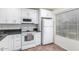 Modern white kitchen with stainless steel appliances and dark countertops at 507 S Sand Verbena Way, Mesa, AZ 85208