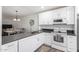 Modern white kitchen with stainless steel appliances and dark countertops at 507 S Sand Verbena Way, Mesa, AZ 85208