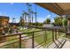 View from patio shows pool, lawn, and palm trees at 6501 N 17Th Ave # 112, Phoenix, AZ 85015