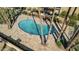 Kidney shaped pool with surrounding stone patio at 6501 N 17Th Ave # 112, Phoenix, AZ 85015