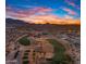 Aerial view of a community with golf course and mountains in background at 6675 S Giralda Ave, Gilbert, AZ 85298