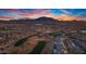 Aerial view of a neighborhood near a golf course and mountains at sunset at 6675 S Giralda Ave, Gilbert, AZ 85298