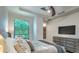 Main bedroom with tufted headboard, neutral decor, and mounted TV at 6803 E Main St # 1110, Scottsdale, AZ 85251