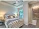 Main bedroom with tufted headboard, neutral decor, and ceiling fan at 6803 E Main St # 1110, Scottsdale, AZ 85251