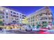 Night view of building exterior, highlighting architectural details and courtyard at 6803 E Main St # 1110, Scottsdale, AZ 85251