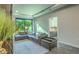 Living room with sectional sofa, large window, and view into bedroom at 6803 E Main St # 1110, Scottsdale, AZ 85251