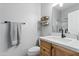 Modern bathroom with wood vanity, white countertop, and black fixtures at 7446 S 30Th Run, Phoenix, AZ 85042
