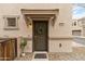 Townhome front door with wreath, small potted plant and light fixture at 7446 S 30Th Run, Phoenix, AZ 85042