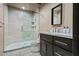 Bathroom with dark vanity, quartz countertop, and a glass shower at 7450 E Continental Mountain Dr # 5, Cave Creek, AZ 85331
