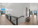 Bright hallway with modern metal railing and wood flooring at 7450 E Continental Mountain Dr # 5, Cave Creek, AZ 85331