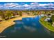 Aerial view of a lake with lush landscaping and homes nearby at 7500 E Mccormick Pkwy # 32, Scottsdale, AZ 85258
